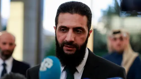 Reuters Ahmed al-Sharaa speaks at a news conference in Damascus, Syria (23 December 2024)