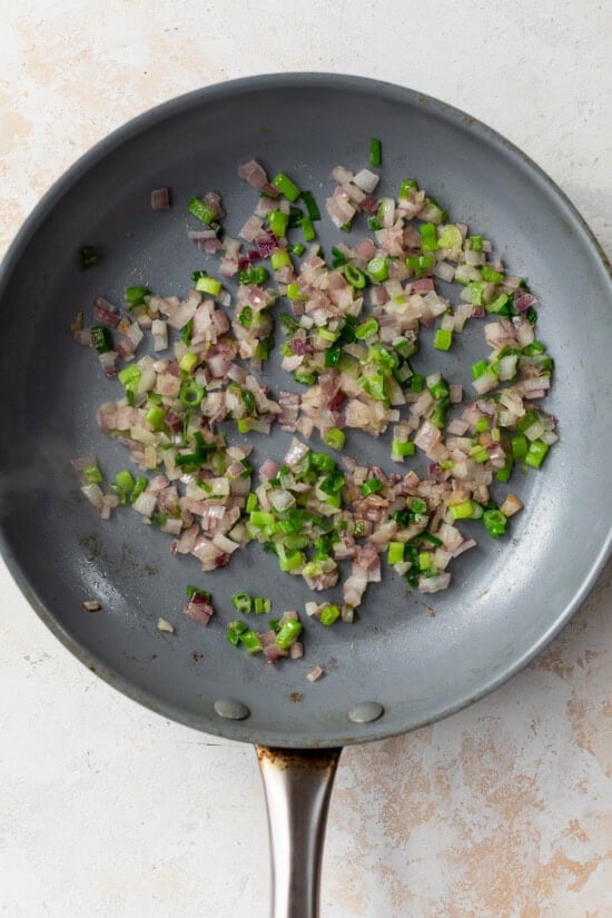 skillet with scallions and red onion