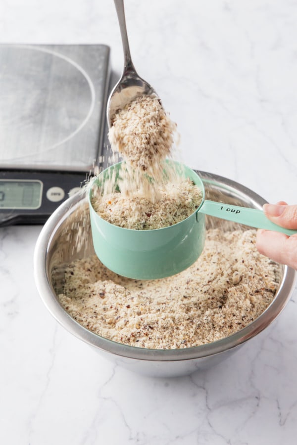 Hazelnut flour being measured by the scoop and sweep method.