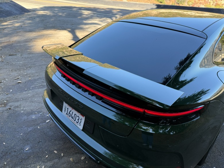 Rear spoiler of a green 2025 Porsche Panamera GTS