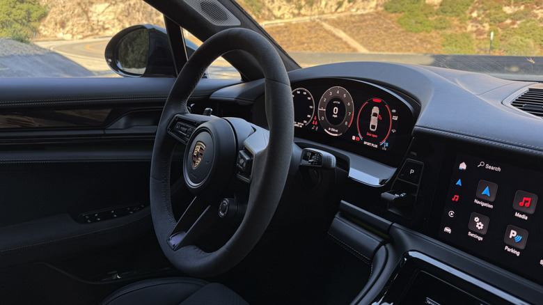 Steering wheel and gauge cluster of a green 2025 Porsche Panamera GTS