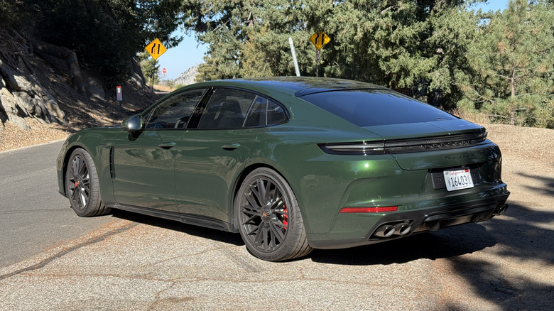 Rear 3/4 view of a green 2025 Porsche Panamera GTS